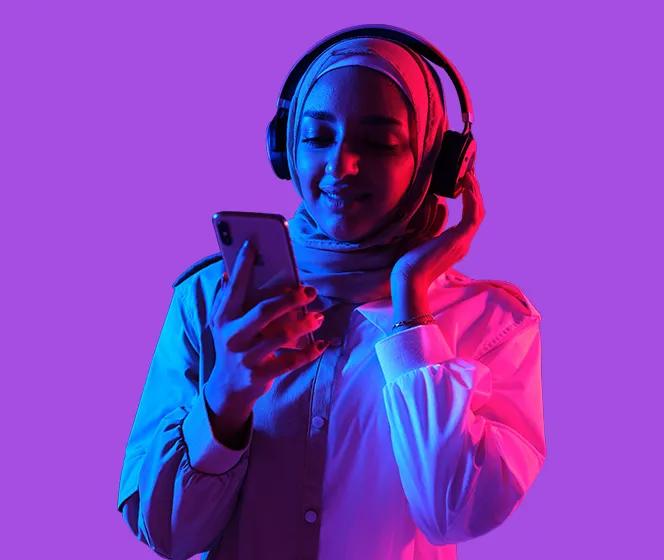  Image of Woman with her phone and listening to music with her headphone