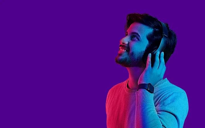 Image of a guy listening to music wearing headphone