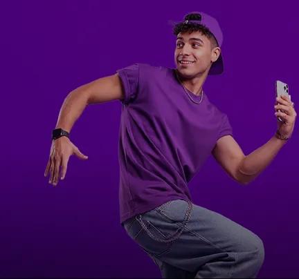 young man using smartphone in an energetic pose