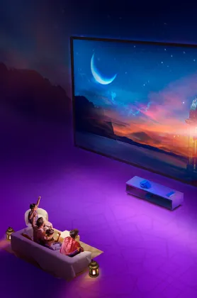 People sitting on a couch and watch TV
